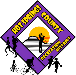 A group of people riding bikes in front of the hot springs county recreation district logo.