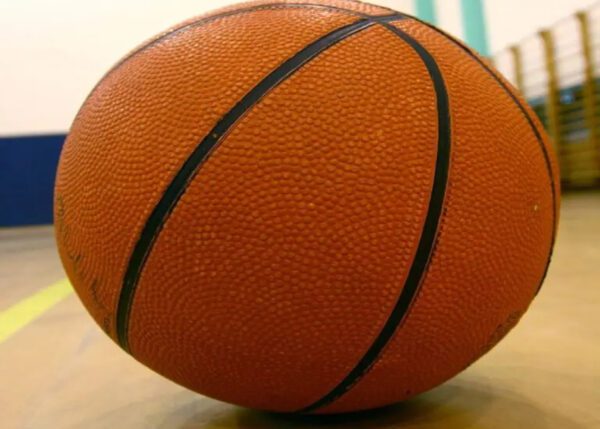 A close up of an orange basketball on the floor